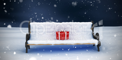 Composite image of digital image of gift box on park bench