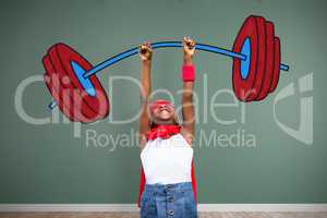 Composite image of smiling girl in red cape with arm raised