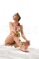 Body art. Beautiful nude girl posing while sitting
