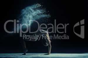 Concept photo. Female dancer in cloud of dust
