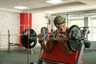 Sport time. Bodybuilder exercising with barbell