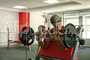 Sport time. Bodybuilder exercising with barbell