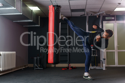 Training time. Image of muscular man boxing at gym