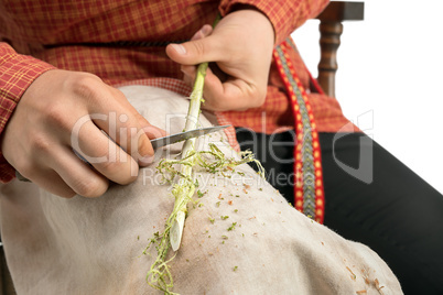 Basketry. Photo of boy barks a twig, close-up