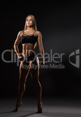 Full length photo of sexy female bodybuilder poses