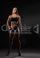 Full length photo of sexy female bodybuilder poses