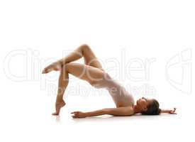 Lovely gymnast posing in studio. Isolated on white