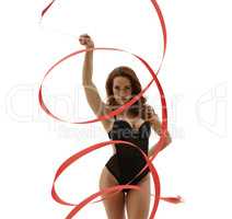 Sexy artistic gymnast posing with ribbon