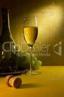 White wine in a glass and grapes