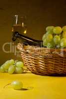 White wine in a glass and grapes