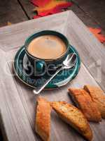Espresso with cantuccini on a wooden plate