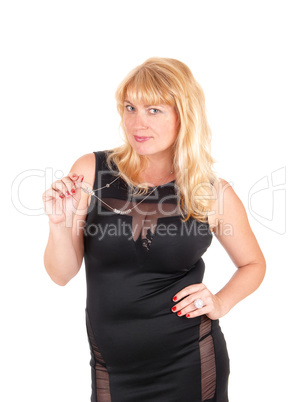 Woman in black dress and necklace.