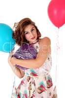 Beautiful woman holding balloons.