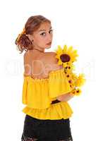 Woman with sunflowers looking over shoulder.