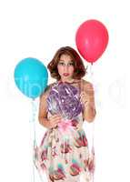 Beautiful woman with lollypop and balloons.