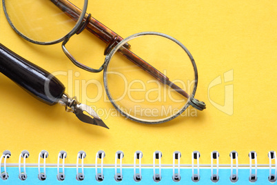 Old Spectacles On Notebook