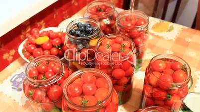 tomatoes in the jars prepared for preservation