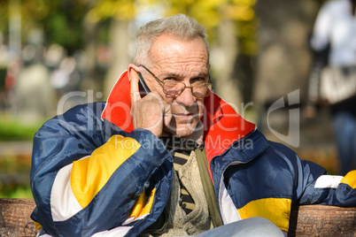 Good looking senior making phone call