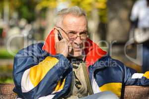 Good looking senior making phone call