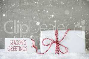 Gift, Cement Background With Snowflakes, Text Seasons Greetings