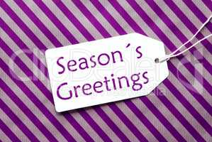 Label On Purple Wrapping Paper, Text Seasons Greetings