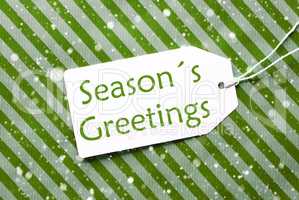 Label On Green Wrapping Paper With Snowflakes, Text Seasons Greetings