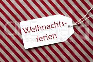 Label On Red Wrapping Paper, Weihnachtsferien Means Christmas Break