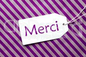 Label On Purple Wrapping Paper, Merci Means Thank You