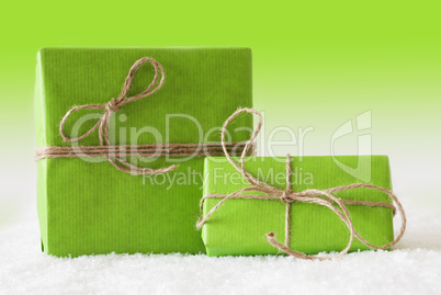 Two Gifts Or Presents On Snow, Green Background