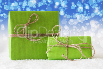 Two Green Gifts On Snow, Blue Bokeh Effect