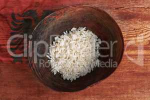 Poverty concept, bowl of rice with Albanian flag