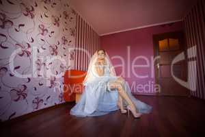The bride in a white dress in the apartment