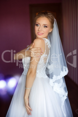 The bride in a white dress in the apartment
