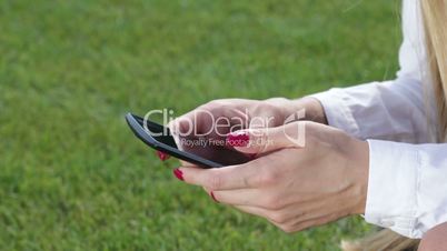 Woman hands with phone touching screen