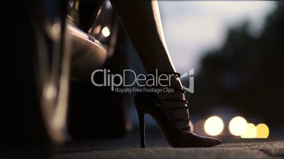 Woman's leg in high heel shoes getting out of car