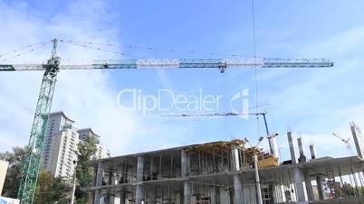 Elevating construction crane against blue sky