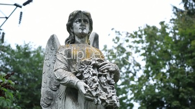Figure of angel as symbol of sorrow at graveyard