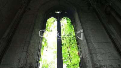 Window opening in ancient stone crypt at graveyard