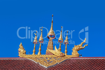 Thailand gold color sculpture on the temple roof