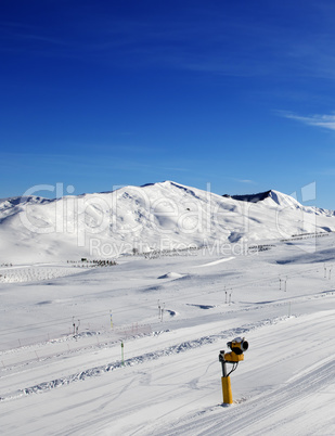 Ski slope with snowmaking at sun day