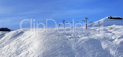 Panoramic view on sunlight off-piste slope at morning