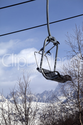 Ski lift in snow mountains at nice winter day