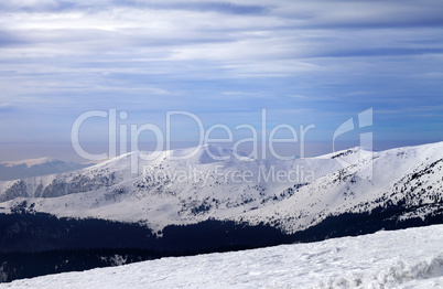 Winter mountains and cloudy sky