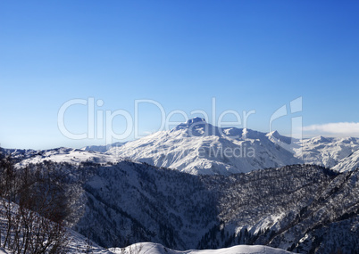 View on snowy mountains and blue sky in sunny morning