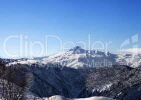 View on snowy mountains and blue sky in sunny morning