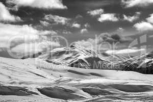 Black and white ski slope and beautiful sky with clouds in sun e