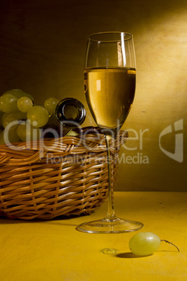 White wine in a glass and grapes