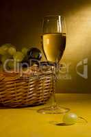 White wine in a glass and grapes