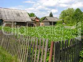 View from the street through a fence at the farm building
