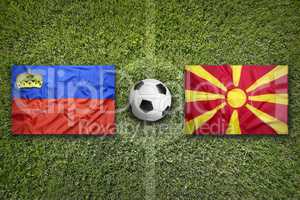 Liechtenstein vs. Macedonia flags on soccer field